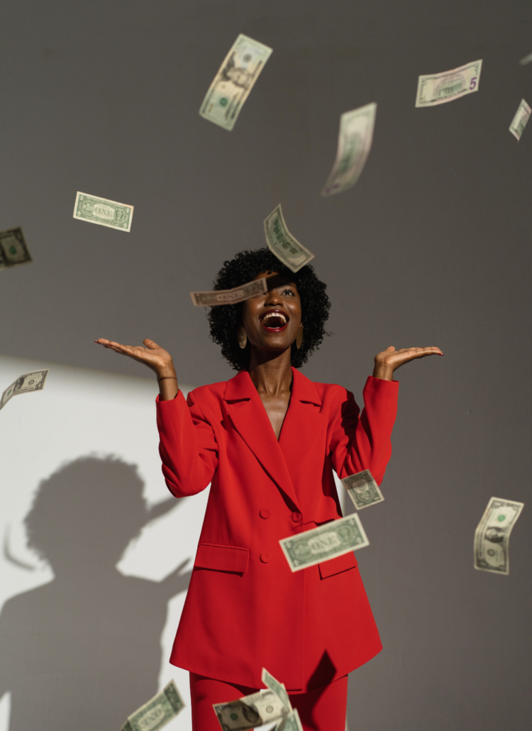 woman joyfully throwing money in the air