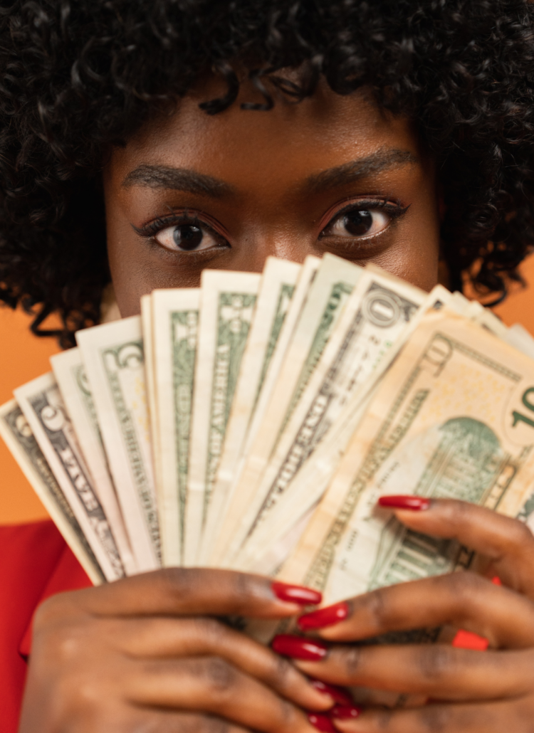 woman with afro showing money