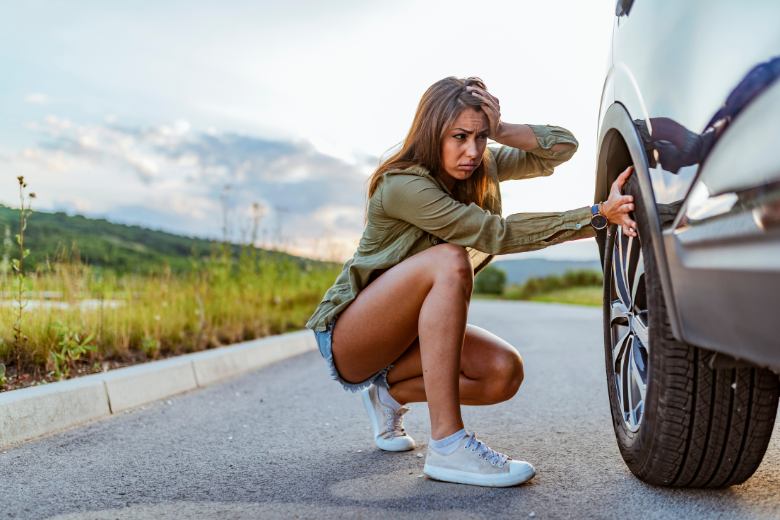 girl stressed about flat tire