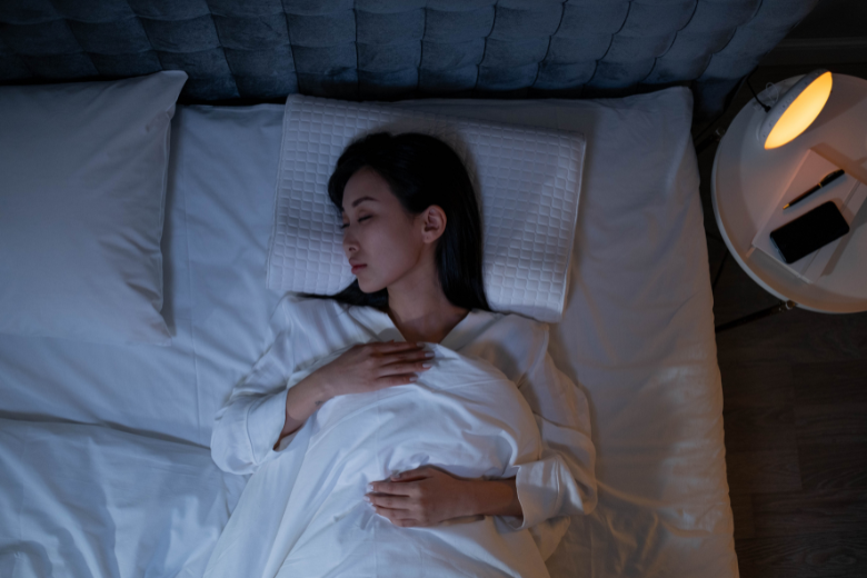 woman sleeping in bed at nighttime