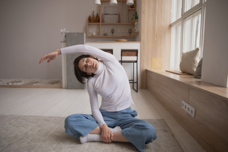 woman-sitting-on-floor-doing-yoga