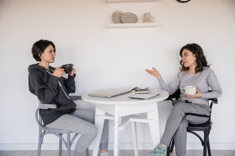 2-women-chatting-at-table