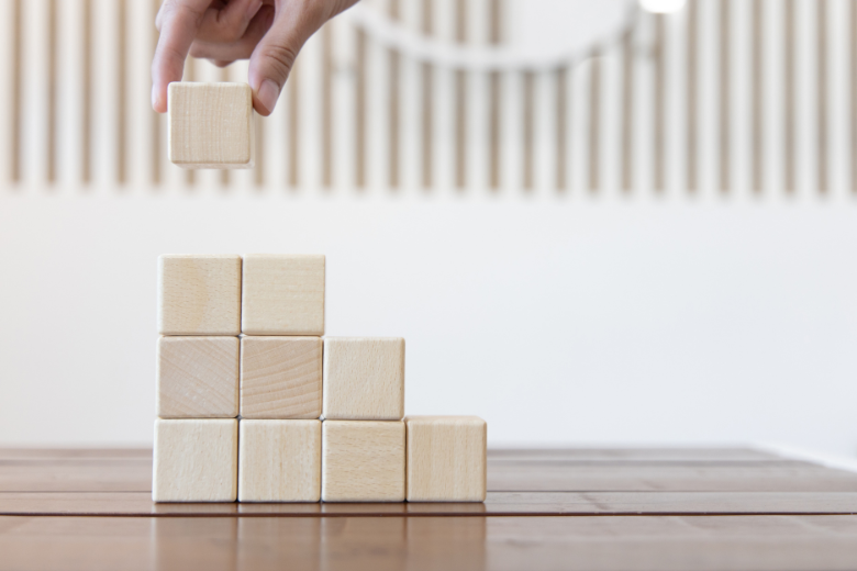 woman-stacking-small-cubes