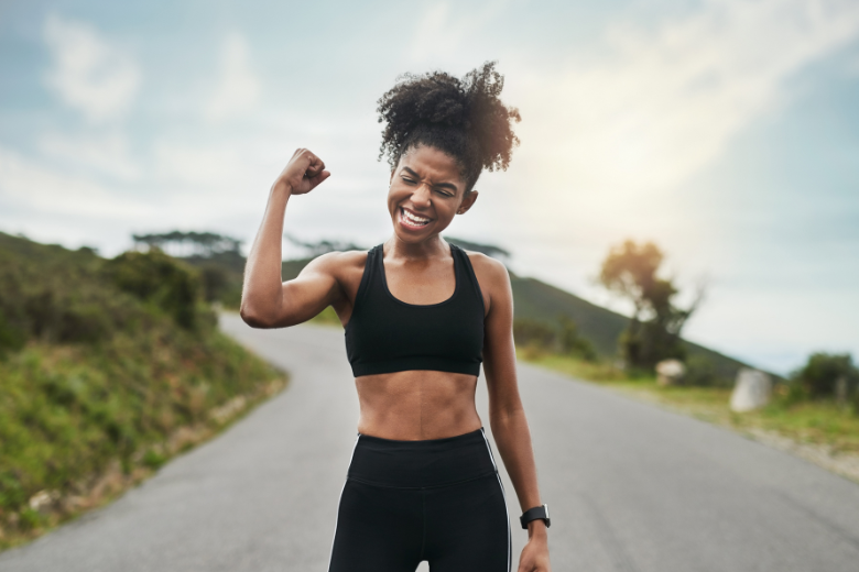 young-sportswoman-flexing-bicep-outside