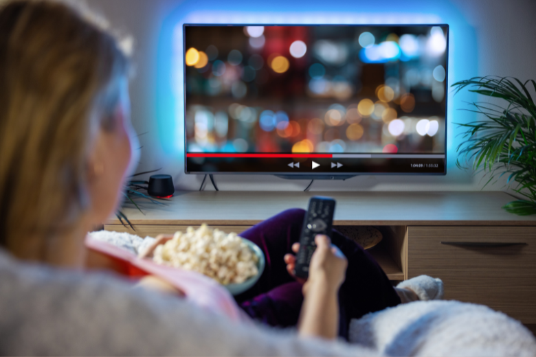 woman-relaxing-at-home-during-evening-watching-TV