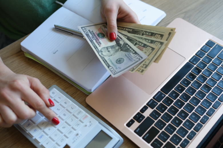 woman-counting-money-and-using-calculator