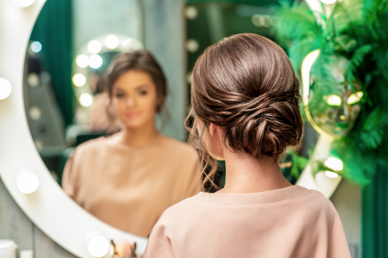 young-woman-looking-at-herself-in-beauty-salon